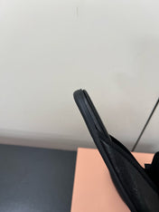 BOW MULES IN BLACK SHEEPSKIN