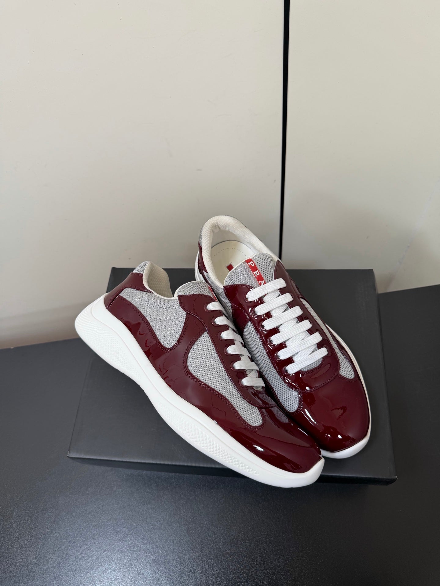 PRADA 26S SNEAKERS IN BURGUNDY RED PATENT CALFSKIN AND WHITE MESH