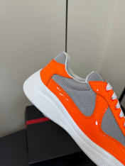 PRADA 26S SNEAKERS IN ORANGE PATENT CALFSKIN AND WHITE MESH