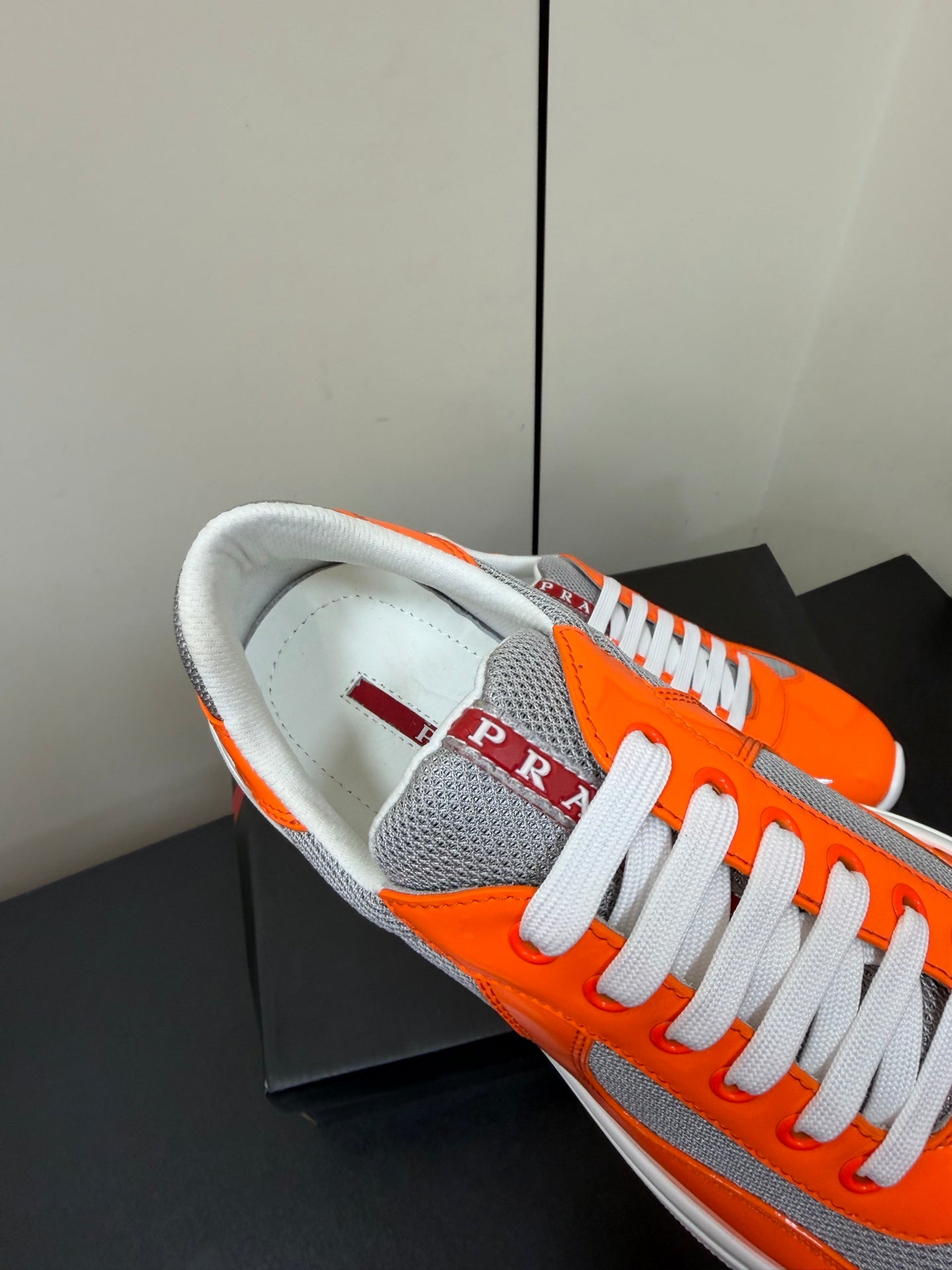 PRADA 26S SNEAKERS IN ORANGE PATENT CALFSKIN AND WHITE MESH