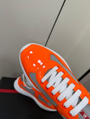 PRADA 26S SNEAKERS IN ORANGE PATENT CALFSKIN AND WHITE MESH
