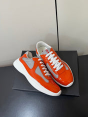 PRADA 26S SNEAKERS IN RED ORANGE PATENT CALFSKIN AND WHITE MESH