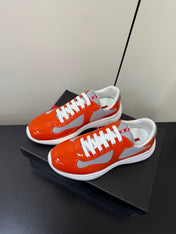 PRADA 26S SNEAKERS IN RED ORANGE PATENT CALFSKIN AND WHITE MESH