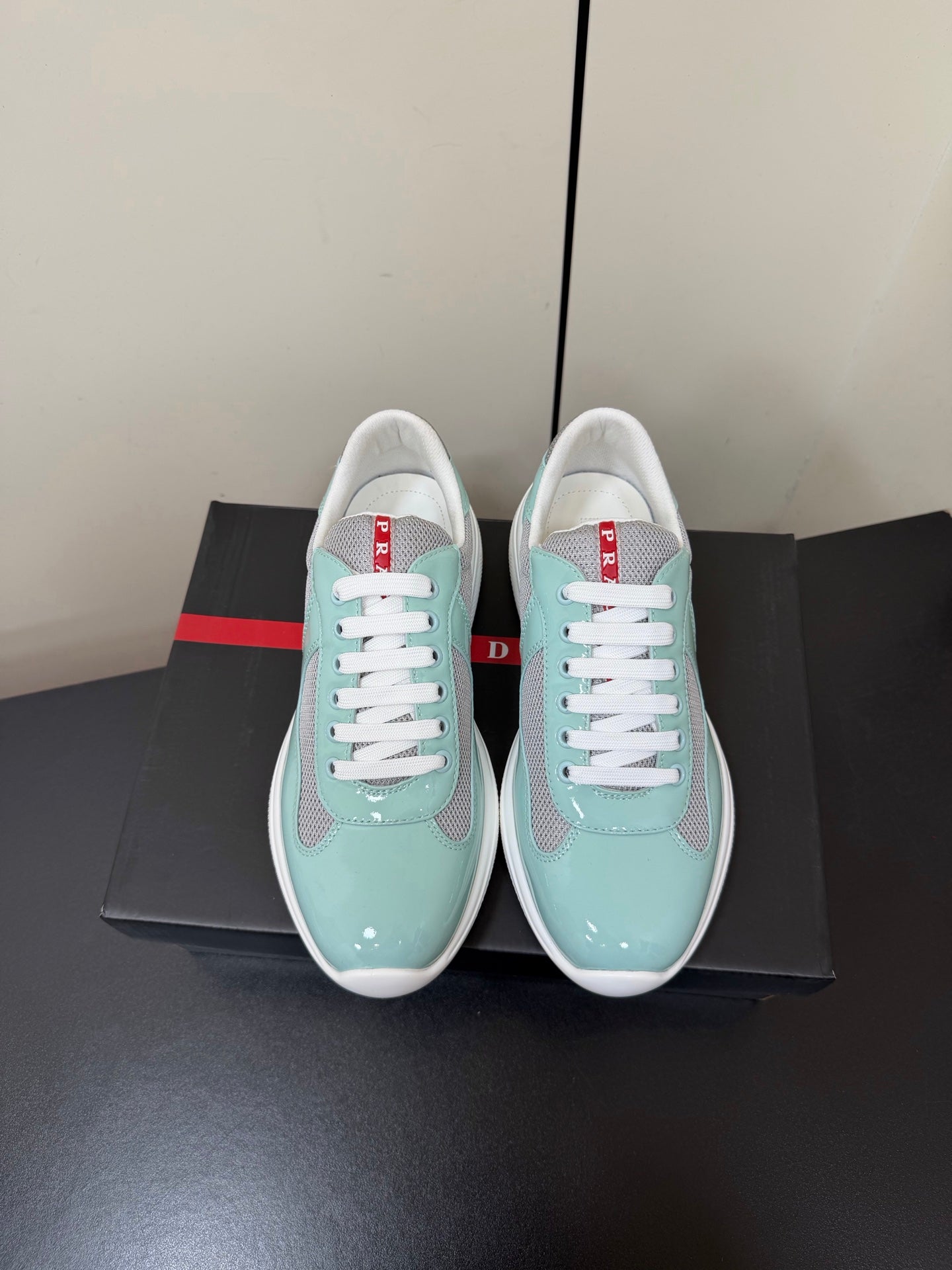 PRADA 26S SNEAKERS IN SOFT TEAL PATENT CALFSKIN AND WHITE MESH