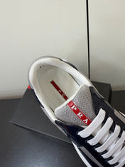 PRADA 26S SNEAKERS IN NAVY BLUE PATENT CALFSKIN AND WHITE MESH