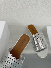ALAIA VIENNE FLAT MULES IN SILVER LAMBSKIN
