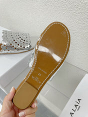 ALAIA VIENNE FLAT MULES IN SILVER LAMBSKIN