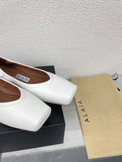 ALAIA BALLET FLATS IN WHITE CALFSKIN