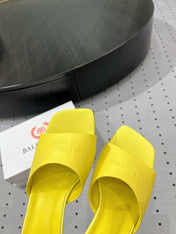 SQUARE-TOE MEDIUM HEEL MULES IN YELLOW CALFSKIN LOGO EMBOSSED