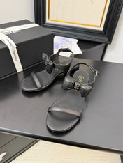 FLAT SANDALS IN BLACK CALFSKIN WITH BOW
