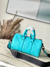 KEEPALL BANDOULIÈRE 25 IN TURQUOISE BLUE MONOGRAM EMBOSSED CALFSKIN