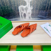 ALFIE LEATHER FLAT MULES IN VIVID ORANGE PATENT CALFSKIN WITH WOVEN DESIGN
