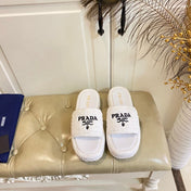 PRADA 26S SLIDE SANDALS IN WHITE LOGO RAFFIA
