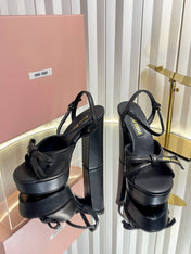 MIUMIU 26S PLATFORM ANKLE STRAP SANDALS 120MM IN BLACK CALFSKIN WITH BOW