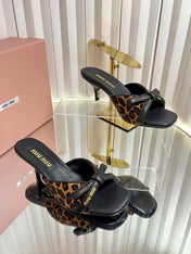 MIUMIU 26S MULE SANDALS 55MM IN LEOPARD PRINT CALF HAIR WITH BOW