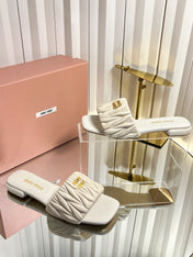 MIUMIU 26S MATELASSE SLIDES IN LIGHT BEIGE CALFSKIN GOLD HARDWARE