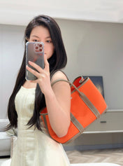 GARDEN PARTY 30CM IN ORANGE MINIMUM TOILETS COTTON CANVAS AND BROWN CALFSKIN