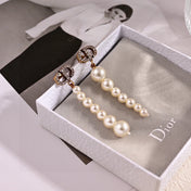 CD 26S PAVE LOGO PEARL DROP EARRINGS IN GOLD TONE METAL 631791