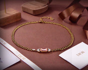CD 26S DIOR LOGO PINK CRYSTAL CHAIN NECKLACE IN AGED GOLD METAL 633118