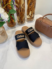 CHLOÉ WOODY WEDGE SANDALS IN BLACK CANVAS WITH CIDER BROWN RUBBER SOLE
