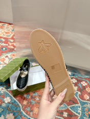 GG CROSS STRAP FLAT SHOES IN BLACK CALFSKIN WITH STRAW SOLE