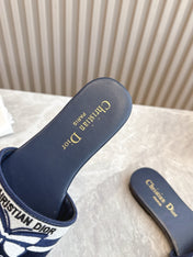 DIOR FLAT SLIDES 25S IN MIDNIGHT BLUE CALFSKIN AND FABRIC EMBROIDERED BUTTERFLY MOTIF