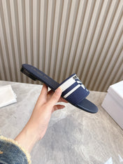 DIOR FLAT SLIDES 25S IN MIDNIGHT BLUE CALFSKIN AND FABRIC EMBROIDERED BUTTERFLY MOTIF