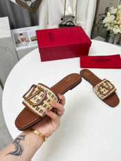 Vlogo embellished leather-trimmed raffia slides tan