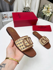 Vlogo embellished leather-trimmed raffia slides tan
