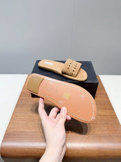 ALAIA FLAT SANDALS WITH PERFORATED STRAPS 25S IN BEIGE SUEDE