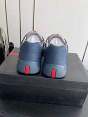 PRADA 26S AMERICA CUP SNEAKERS IN SLATE BLUE SOFT RUBBER AND BIKE FABRIC
