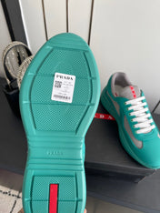 PRADA 26S AMERICA CUP SNEAKERS IN TEAL BLUE SOFT RUBBER AND BIKE FABRIC