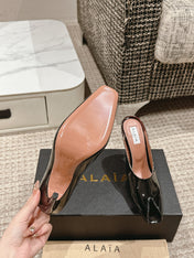 ALAIA SPIKE JEWEL MULES IN BLACK GLOSSY CALFSKIN