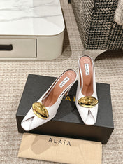 ALAIA SPIKE JEWEL MULES IN WHITE CALFSKIN WITH GOLD HARDWARE