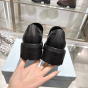 PRADA 25S THICK-SOLE LOAFERS 60 MM IN BLACK SMOOTH CALFSKIN