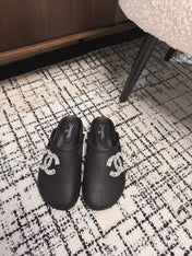 FLAT MULES IN BLACK CALFSKIN