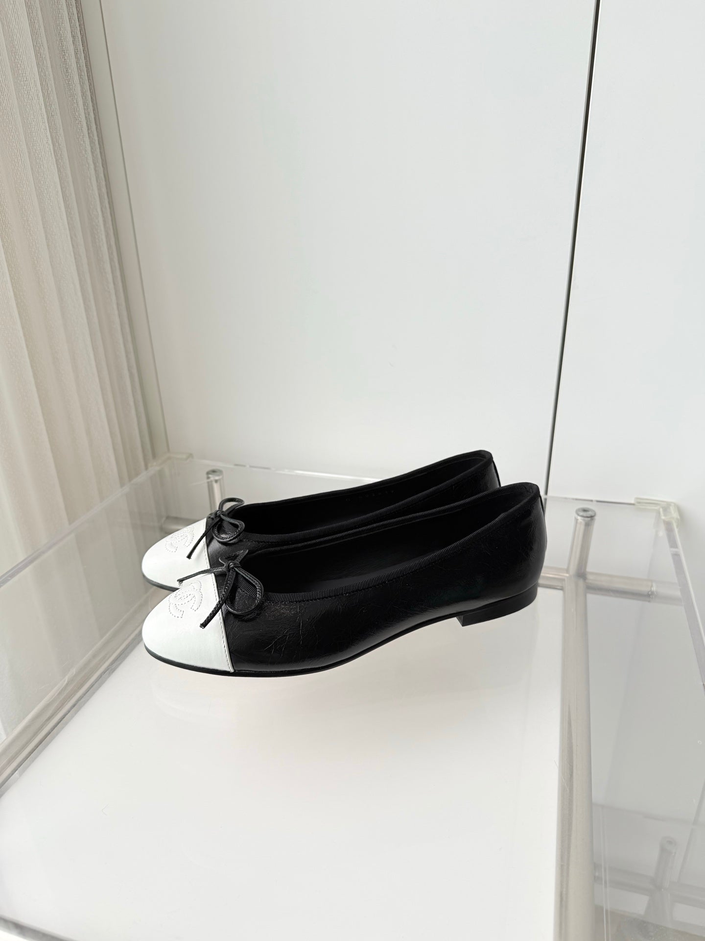 CHANEL 26S BALLET FLATS IN BLACK CRACKED CALFSKIN WITH WHITE TOE CAP AND BOW