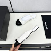 BOW MULE IN WHITE FUR AND BLACK CALFSKIN