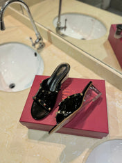 ROCKSTUD MULE SANDALS WITH TRANSPARENT HEEL IN BLACK CALFSKIN