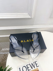 ALAIA 26S POINTED-TOE THONG SANDALS IN BLACK SATIN AND TRANSPARENT PVC
